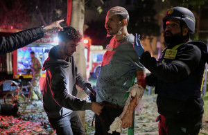 <p>Rescue workers bandage a wounded man and provide first aid at the site of a direct hit from an Iranian missile strike in Tel Aviv, Israel, Saturday, Feb. 28, 2026. (AP Photo/Tomer Neuberg)</p>