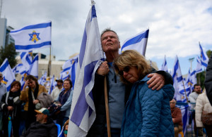 <p>People gather, on the day the bodies of deceased Israeli hostages, Oded Lifschitz, Shiri Bibas and her two children Kfir and Ariel Bibas, who were kidnapped during the deadly October 7, 2023 attack by Hamas, are handed over under the terms of a ceasefire between Hamas and Israel, in Tel Aviv, Israel February 20, 2025. REUTERS/Ammar Awad</p>