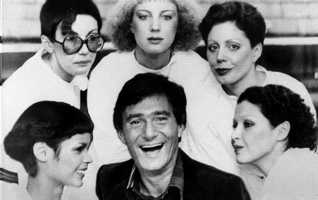 <p>Hairstylist Vidal Sassoon is surrounded by models, showing his new cuts for 1976, in London, on Jan.23, 1976. The styles are called, clockwise from lower left; The Hummingbird, Question Mark, Feathers, Tomboy and Silver Lady. (AP Photo)</p>