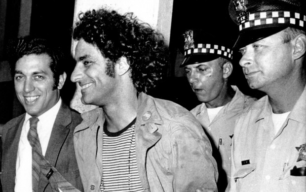 <p>Abbie Hoffman, leader of the Youth International Party known as the Yippies, is escorted by police after his arrest at O'Hare Field in Chicago upon his arrival from New York on Sept. 17, 1968. He was sought for not appearing in court on Sept. 6 to answer charges of disorderly conduct and resisting arrest. Police said a switchblade knife and a knife with a four-inch blade was found on Hoffman, who was then booked on charges of unlawful use of weapon. At left is his attorney Gerald B. Lafcourt. (AP Photo)</p>