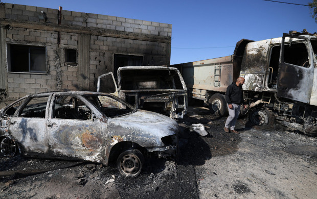 <p>A Palestinian inspects the damage to vehicles in the village of Mughayir near Ramallah in the Israeli-occupied West Bank on April 13, 2024, set ablaze by Israeli settlers during an attack on the village. (Photo by JAAFAR ASHTIYEH / AFP)</p>