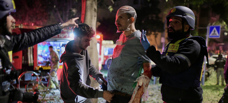<p>Rescue workers bandage a wounded man and provide first aid at the site of a direct hit from an Iranian missile strike in Tel Aviv, Israel, Saturday, Feb. 28, 2026. (AP Photo/Tomer Neuberg)</p>